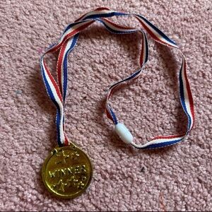 Gold Winner Medal with Red, White, and Blue Ribbon